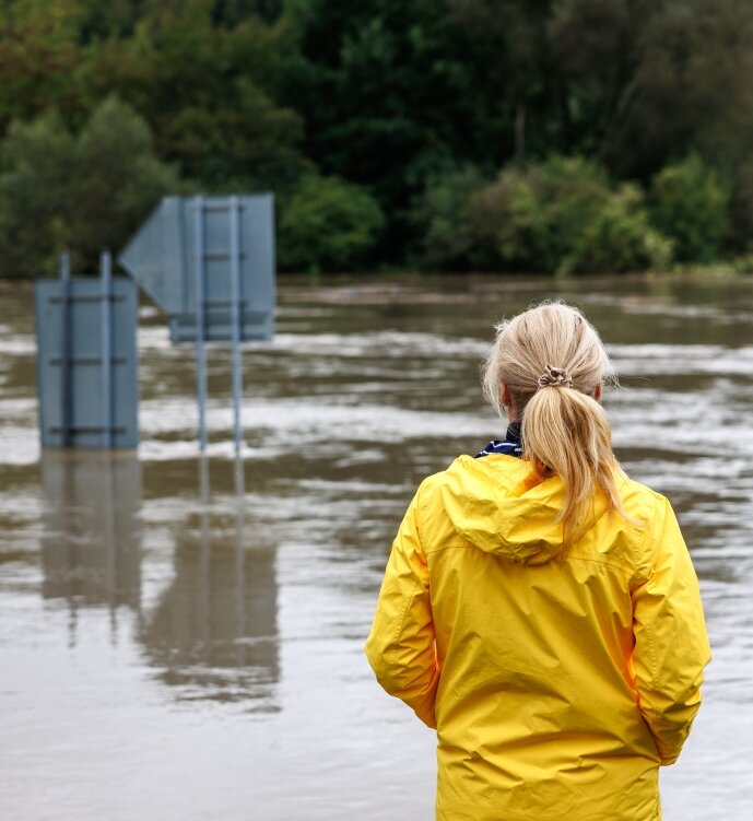 Someone looking over a flooded street.